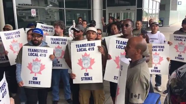Striking Swissport employees, members of Teamsters Local 419, picket at Toronto Pearson International Airport.