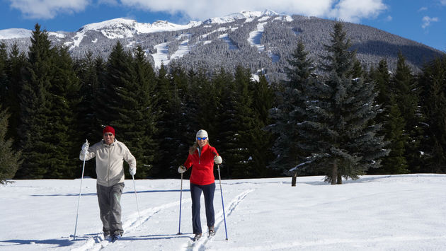 Man and woman skiing in Whistler, British Columbia