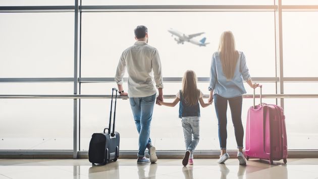 Family in airport (Photo via Vasyl Dolmatov / iStock / Getty Images Plus)