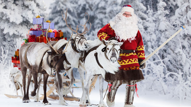A Santa Claus with his reindeer and sleigh.