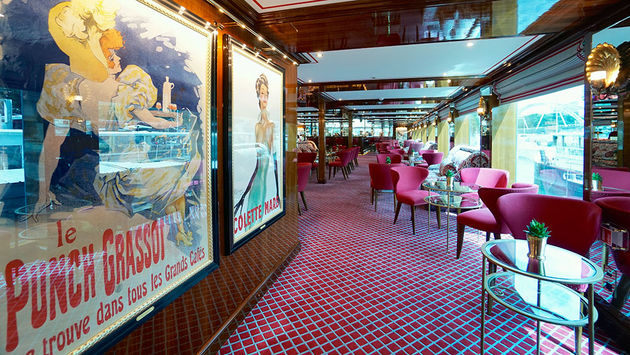 Vintage posters lead guests into the Salon Toulouse onboard Uniworld Boutique River Cruise Collection's S.S. Joie de Vivre