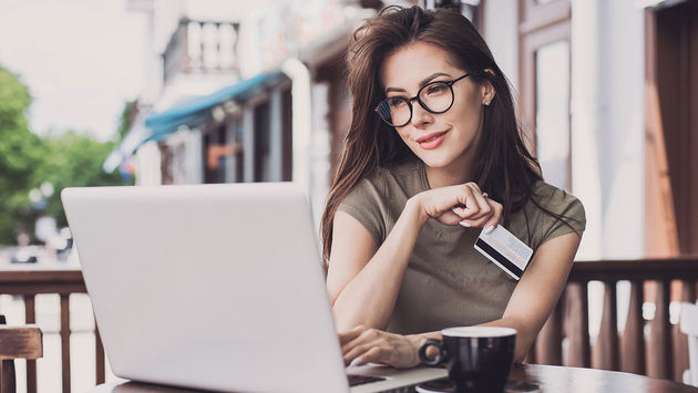 Woman is online with laptop computer and credit card (Photo via Poike / iStock / Getty Images Plus)