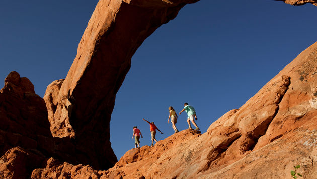 A family hiking Arches National Park near Moab, Utah