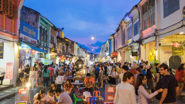 Tourists shopping at a night market in Phuket, Thailand