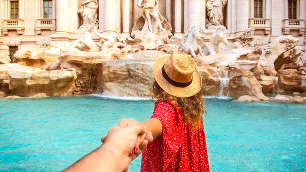 Couple holding hands in Rome, Italy