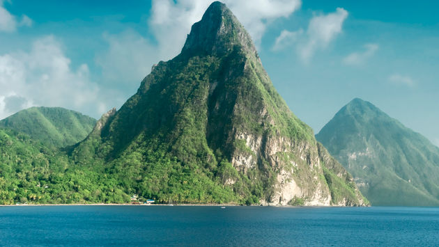 View of the famous Piton mountains in St Lucia (photo via dani3315 / iStock / Getty Images Plus)