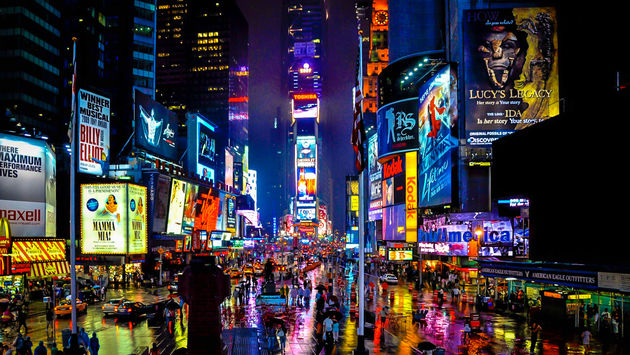 Times Square in New York on a rainy night. (schalkm / iStock / Getty Images Plus)
