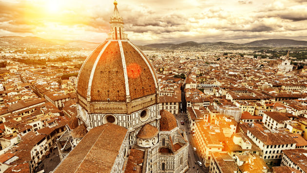 Florence sunny view, Italy. The Basilica di Santa Maria del Fiore (Basilica of Saint Mary of the Flower) in the foreground. (photo via scaliger / iStock / Getty Images Plus)